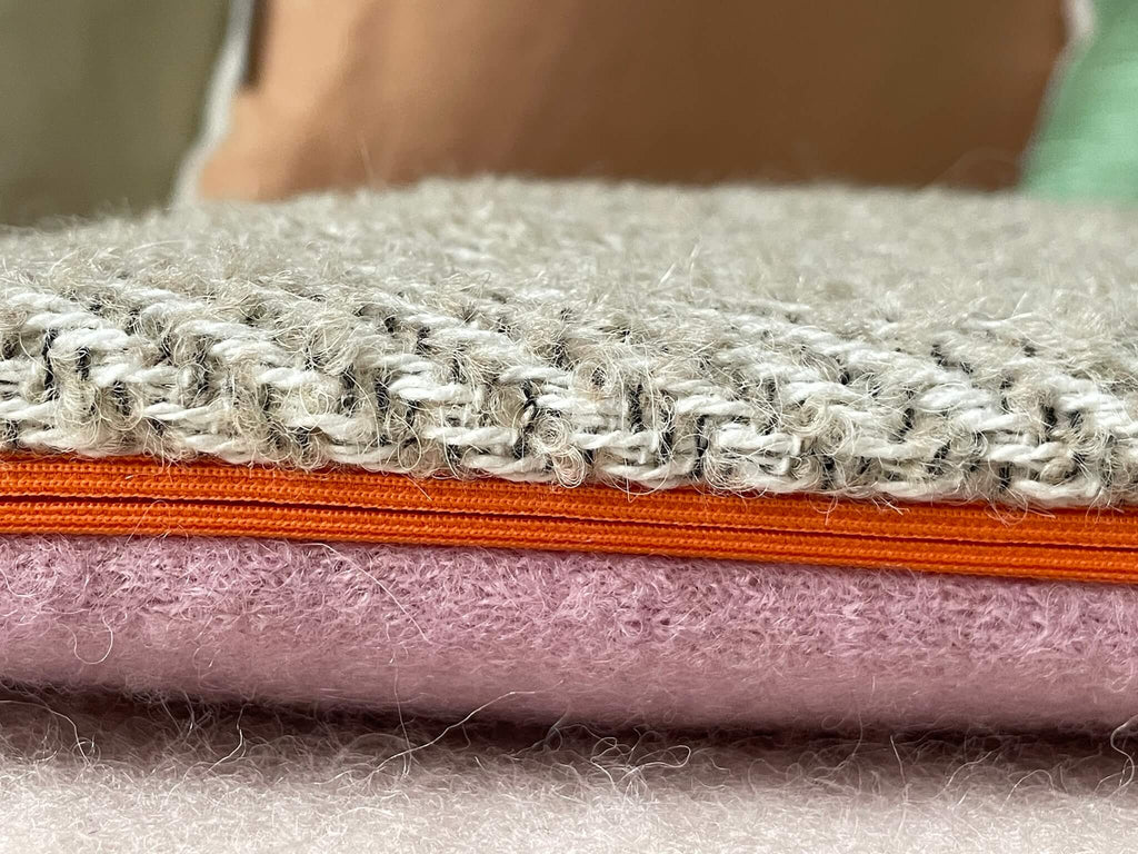 Detailansicht Wärmflaschenbezug aus beiger und rosa Wolle mit orangem Reißverschluss